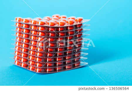 Stack of chondroprotector tablets on a blue background. Glucosamine and chondroitin for joints. Copy space for text, anti-inflammatory Stack of chondroprotector tablets on a blue background. Glucosamine and chondroitin for joints. Copy space for text, anti-inflammatory 136506564