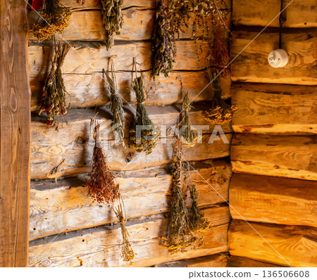 Medicinal herbs in a rustic herbalist's shop against a wooden log wall. Nettle, thyme, and fireweed. Herbal treatment 136506608