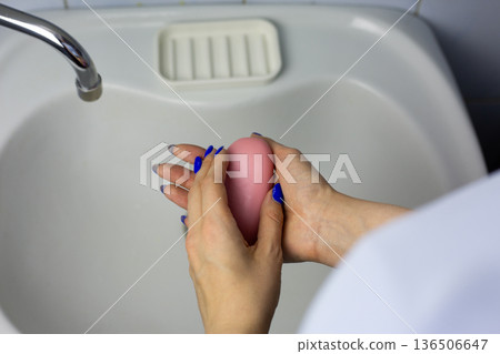 Close up photo of women hands with soap. Handwashing against sink. Concept of daily handwashing routine. Skin hygiene, protection from bacteria. Process everyone does Close up photo of women hands with soap. Handwashing against sink. Concept of daily handwashing routine. Skin hygiene, protection from bacteria. Process everyone does 136506647