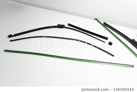 Collection of multiple car windshield wiper blade refills and components for automobile maintenance on clean white background studio shot 136506938