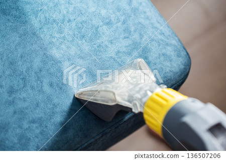 Cleaning upholstery with a vacuum attachment for deep cleaning fabric surfaces at home Cleaning upholstery with a vacuum attachment for deep cleaning fabric surfaces at home 136507206
