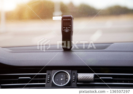 Alcohol Tester On Vehicle Dashboard With Sun Flare. Sobriety Check Device In Morning Light. 136507297