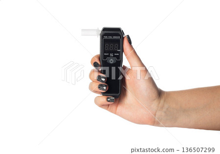 Woman's Hand With Manicure Holding Digital Breathalyzer. Female Hand With Sobriety Tester Isolated, isolate Woman's Hand With Manicure Holding Digital Breathalyzer. Female Hand With Sobriety Tester Isolated, isolate 136507299