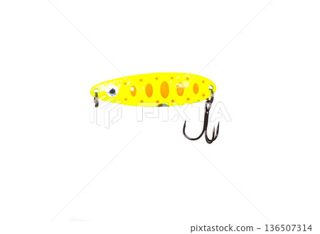 Yellow fishing spoon bait for sport fishing hobby isolated on white background. Metal artificial lure with orange spots and treble hook. 136507314