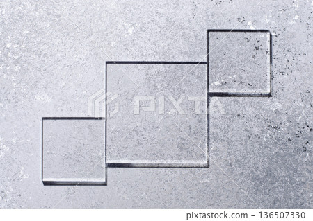 Glass squares on a gray background. Copy space Glass squares on a gray background. Copy space 136507330