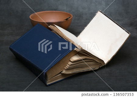Two books bound together with sheets of paper Two books bound together with sheets of paper 136507353