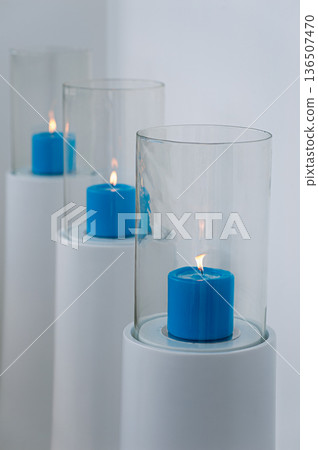 Blue Candle Inside Glass Cylinder Lantern on White Stand  Modern Minimalist Decor 136507470