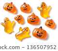 Colorful Halloween-themed gummy candies shaped like pumpkins and ghosts, arranged playfully on a white background, perfect for festive celebrations and seasonal treats 136507952