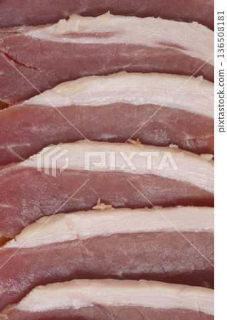 Slices of dry cured prosciutto ham arranged in a row 136508181