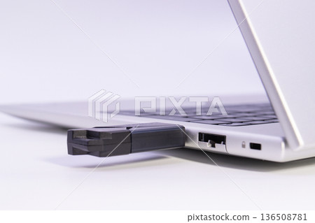 USB flash drive plugged into laptop usb port showing external storage connection 136508781