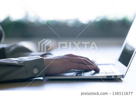 Man working on laptop 136511677