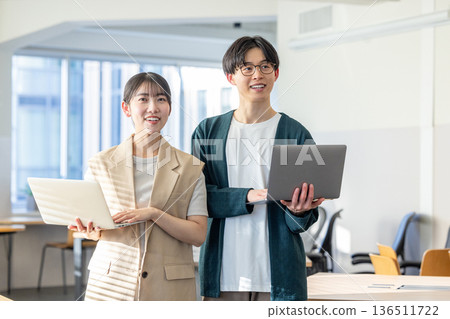 Male and female engineers working in the office 136511722