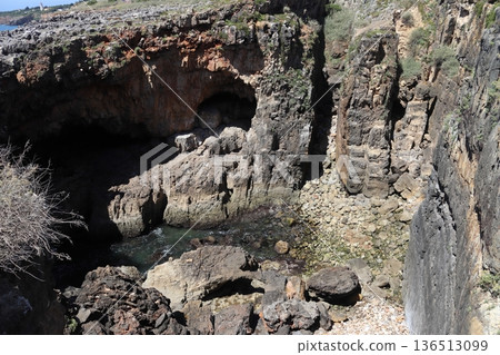 Deep sea cave and rugged limestone cliffs at Boca do Inferno, Cascais. Deep sea cave and rugged limestone cliffs at Boca do Inferno, Cascais. 136513099