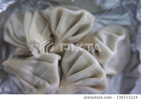Close-up of Khinkali steamed Georgian dumplings on foil Close-up of Khinkali steamed Georgian dumplings on foil 136513224