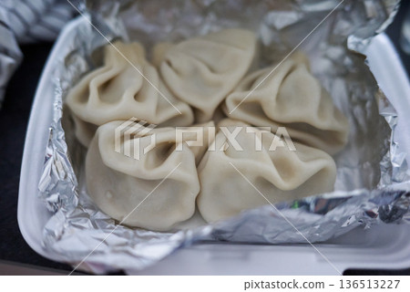 Close-up of Khinkali steamed Georgian dumplings on foil Close-up of Khinkali steamed Georgian dumplings on foil 136513227