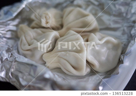 Close-up of Khinkali steamed Georgian dumplings on foil Close-up of Khinkali steamed Georgian dumplings on foil 136513228