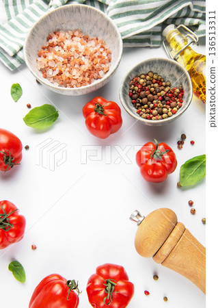 Fresh tomatoes, herbs, and spices on white background 136513311