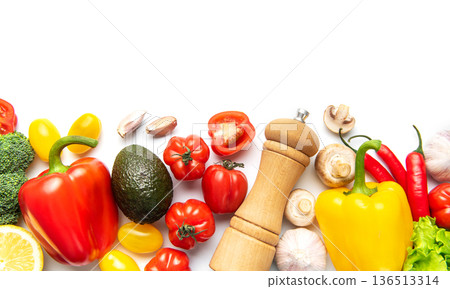 Fresh colorful vegetables around pepper mill creating border Fresh colorful vegetables around pepper mill creating border 136513314