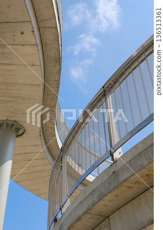 Curved concrete architecture against blue sky Curved concrete architecture against blue sky 136513361