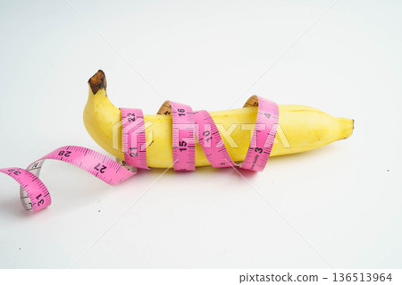 Banana with measuring tape, penis health. Banana with measuring tape, penis health. 136513964