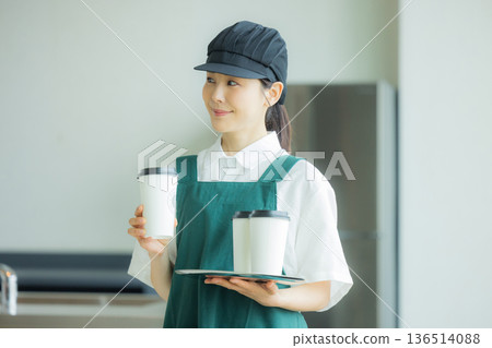 Young female clerk working in a cafe 136514088