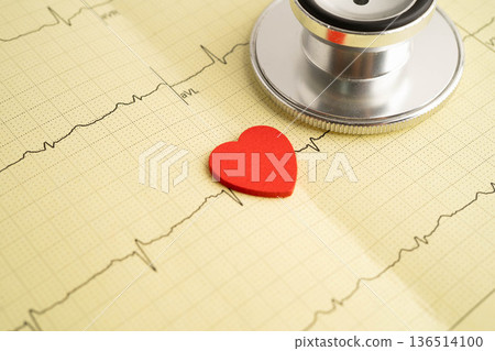 Stethoscope on electrocardiogram ECG, heart wave, heart attack, cardiogram report. Stethoscope on electrocardiogram ECG, heart wave, heart attack, cardiogram report. 136514100