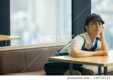 A cafe employee with a troubled face A cafe employee with a troubled face 136514127
