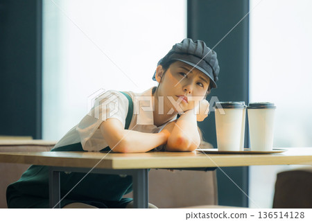 A cafe employee with a troubled face A cafe employee with a troubled face 136514128