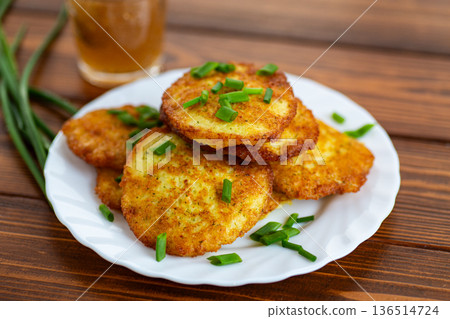 Crispy homemade potato pancakes served on white plate 136514724