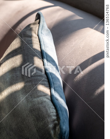 Gray cushions on a gray sofa. Same color but different texture 136514768