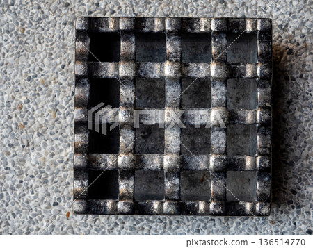 A cast metal box is used as an ashtray A cast metal box is used as an ashtray 136514770