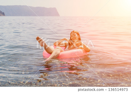 Woman relaxing summer float, young person swimming water tube sea ocean vacation travel enjoyment lifestyle Woman relaxing summer float, young person swimming water tube sea ocean vacation travel enjoyment lifestyle 136514973