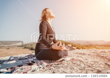Woman Meditating on a Mountaintop Woman Meditating on a Mountaintop 136514984