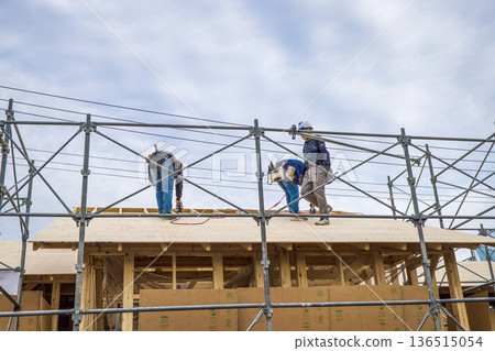 Image of a house: A wooden one-story house under construction with roof sheathing Image of a house: A wooden one-story house under construction with roof sheathing 136515054
