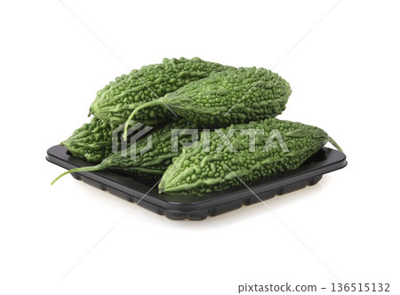 Fresh bitter gourd Bitter cucumber or bitter melon with cut slice isolated on a white background. Fresh bitter gourd Bitter cucumber or bitter melon with cut slice isolated on a white background. 136515132