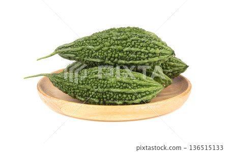 Fresh bitter gourd Bitter cucumber or bitter melon with cut slice isolated on a white background Fresh bitter gourd Bitter cucumber or bitter melon with cut slice isolated on a white background 136515133