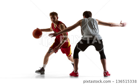 Basketball player dribbling past opponent with defensive stance on white background Basketball player dribbling past opponent with defensive stance on white background 136515338