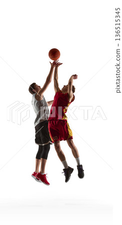 Two basketball players fighting for rebound midair isolated in studio. 136515345