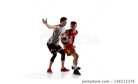 Basketball defender raising arm to block shot in studio isolated on white background. 136515376