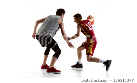 Basketball player turning back while protecting ball from defender isolated on white. 136515377