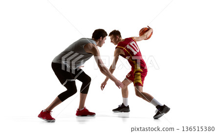 Basketball players facing off in one on one play isolated on white background 136515380