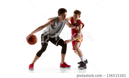 Two basketball athletes contesting ball during intense match isolated on white background. 136515381