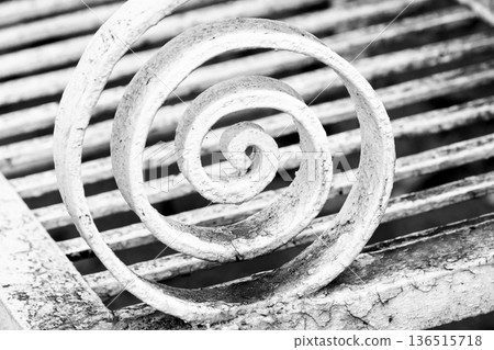 Monochrome close-up of a weathered wrought iron spiral Monochrome close-up of a weathered wrought iron spiral 136515718