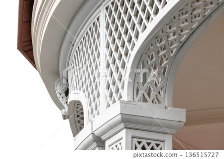 Close-up of a white lattice arch and carved columns Close-up of a white lattice arch and carved columns 136515727