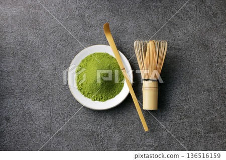 Gray stone background and vibrant matcha powder Gray stone background and vibrant matcha powder 136516159