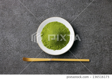 Gray stone background and vibrant matcha powder Gray stone background and vibrant matcha powder 136516173