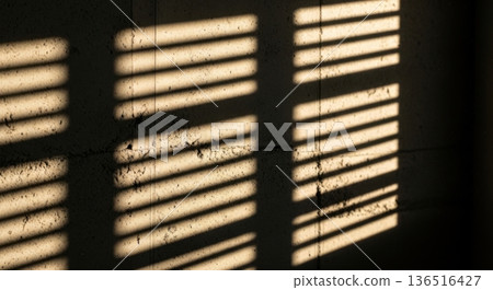 Sunlight Rays Through Blinds Casting Shadows on Dark Wall Sunlight Rays Through Blinds Casting Shadows on Dark Wall 136516427