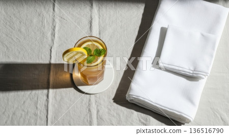 Minimalist Iced Tea with Lemon and Mint on Linen Tablecloth Minimalist Iced Tea with Lemon and Mint on Linen Tablecloth 136516790
