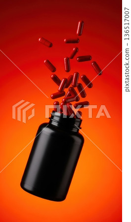 Explosion of Red Capsules Flying Out of Black Supplement Bottle 136517007