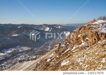 Torgashinsky ridge, Krasnoyarsk, Siberia. Scenic winter mountain landscape with snowy valley view. Panoramic frozen peak vista for nature travel and outdoor adventure. 136517879